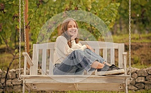 positive emotions. smiling child on swing. kid swinging outdoor. teen girl having fun