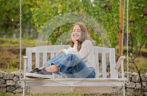 positive emotions. smiling child on swing. kid swinging outdoor. teen girl having fun