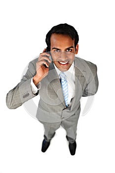 Positive ethnic businessman on phone