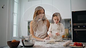 Positive family decorating pie at kitchen closeup. Funny child girl eating apple