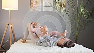 Positive family moments, mother with infant kids playing and having fun, being in good playful mood, expressing happiness, young