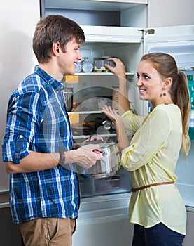 Positive family searching food on fridge photo