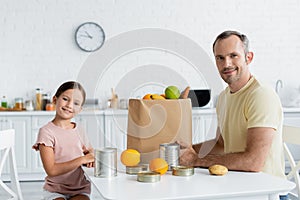 Positive father and daughter looking at