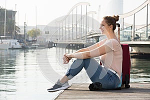 female tourist standing at pier in cold spring day