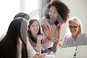 Positive friendly diverse team employees talking laughing at company meeting