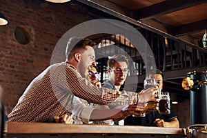 Positive friends. People in casual clothes sitting in the pub