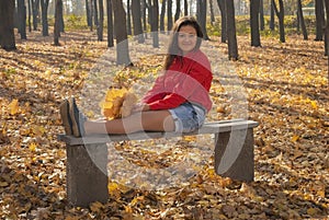 Positive girl in autumn park.