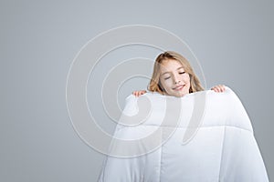 Positive girl holding blanket