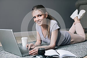 Positive girl with laptop surfing Internet.