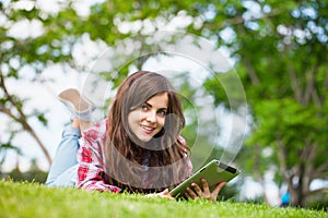 Positive girl lying on the grass