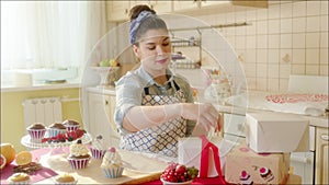 Positive girl putting cake in the box