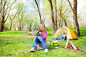 Positive girl with red backpack and binocular