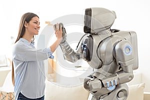 Positive girl and robot giving high five