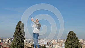 A positive girl takes a selfie against the backdrop of Cartagena Spain.