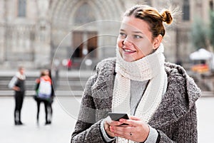 Positive girl teenager with phone