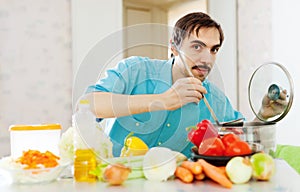 Positive guy doing veggy lunch