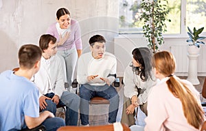 Positive guy team leader holding meeting with group of students