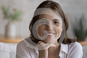 Positive happy freckled girl with natural fresh complexion facial portrait