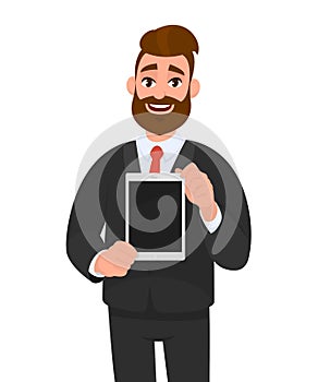 Positive happy young bearded business man showing/holding blank screen of digital tablet computer in hands. Modern technology.