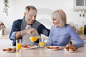 positive healthy pensioners enjoying delicious breakfast together