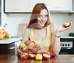 Positive houswife holding peaches