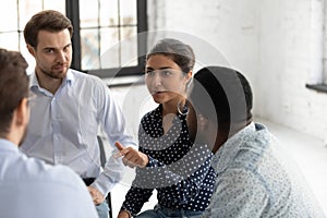 Positive Indian woman psychologist coach speaking at meeting