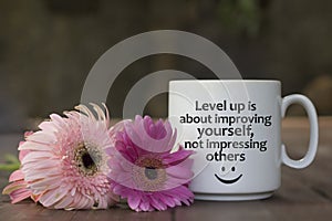 Positive inspirational messages on coffee cup with pink flowers - Level up is about improving yourself, not impressing others.