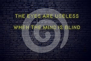 Positive inspiring quote on neon sign against brick wall the eyes are useless when the mind is blind photo