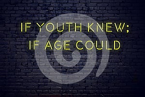 Positive inspiring quote on neon sign against brick wall if youth knew if age could