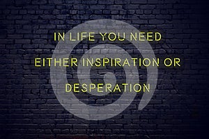 Positive inspiring quote on neon sign against brick wall in life you need either inspiration or desperation