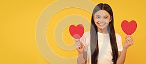 positive kid hold love heart on yellow background, love day. Kid girl portrait with heart love symbol, horizontal poster