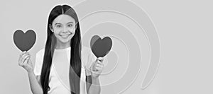 positive kid hold love heart on yellow background, love day. Kid girl portrait with heart love symbol, horizontal poster