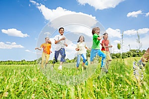 Positive kids playing and running in the field