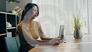 Positive lady communicate with family by videocall .