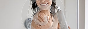 Positive lady with shiny smile showering in bathroom advertizing shampoo