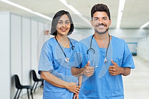 Positive latin american male and female nurses at vaccination station