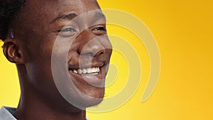 Positive lifestyle. Close up of happy young african american man laughing happily over yellow background, free space