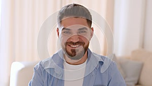 Positive lifestyle. Close up portrait of young handsome middle eastern man smiling to camera, slow motion