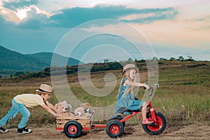 Positive little girl and boy. Little children have fun on fresh air. Walk on countryside. Children play outdoors. While