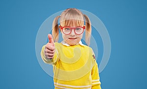 Positive little girl showing thumb up