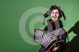 A very positive man with an accordion posing in the studio