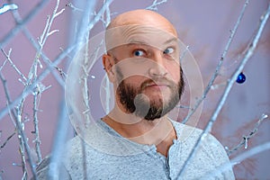 Positive man in Christmas decorations festive mood