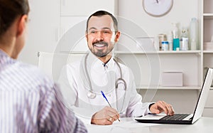 Positive man doctor with female visitor