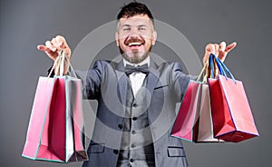 Positive man enjoying shopping. businessman in bow tie. stylish esthete with shopping bags. holiday purchase. business