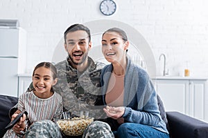 Positive man in military uniform sitting