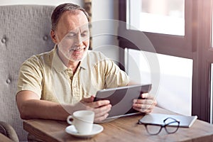 Positive man using tablet