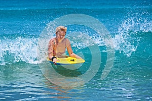 Positive mature woman surfing with fun on ocean waves