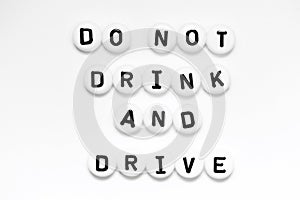 A positive message DO NOT DRINK AND DRIVE written on white circles isolated on a white background