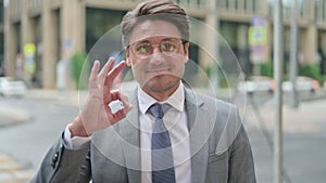 Positive Middle Aged Businessman showing OK Sign