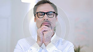 Positive middle aged man praying to god for help, believe